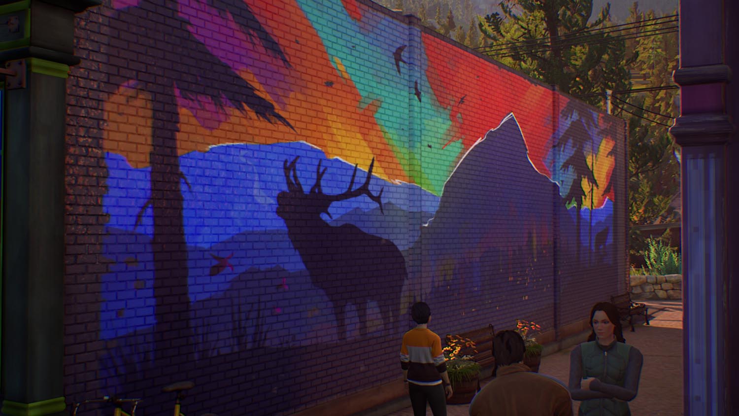 Zu sehen ist ein großes Wandbild, das einen Wald in den Farben eines dunklen Regenbogens erstrahlen lässt, ein Hirsch röhrt da ebenfalls drauf, neben dem Hirsch ist ein Nadelbaum und ein großer Berg zu sehen.